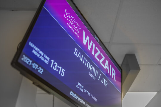 07.22.20, Santorini, Greece: close up view of departure screen in Santorini airport. Wizzair low coast airlines. Arrival time, gate. Screen of travel sign