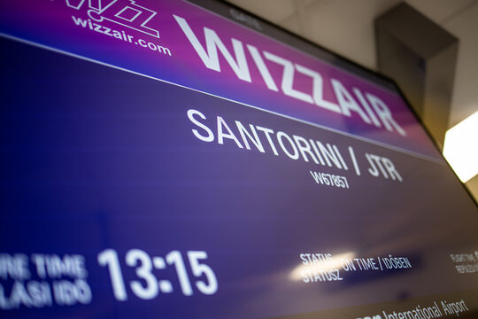 07.22.20, Santorini, Greece: close up view of departure screen in Santorini airport. Wizzair low coast airlines. Arrival time, gate. Screen of travel sign
