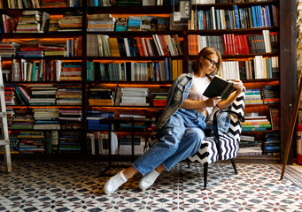 Young female student study in the library holding book , education concept