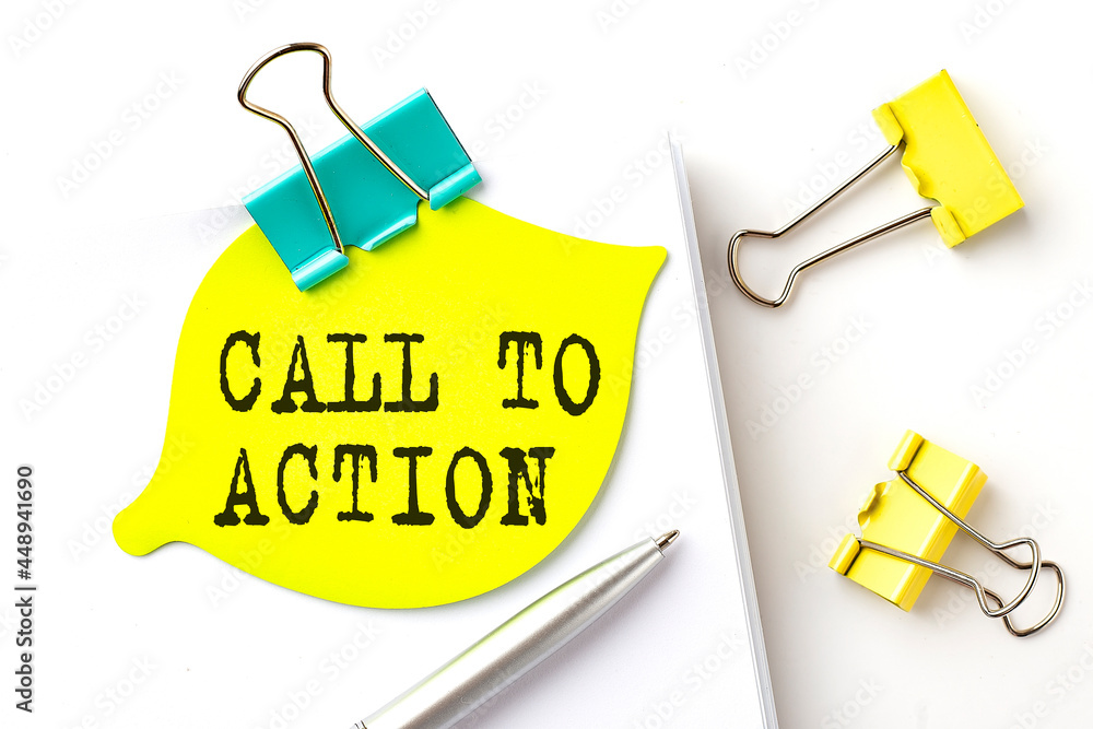 Poster sticker with call to action text on notebooks on the white background