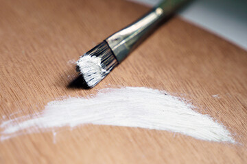 Brush in oil paint on a palette