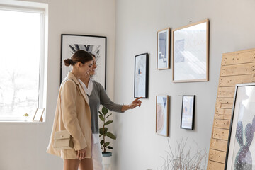 Women at exhibition in modern art gallery