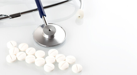 Doctors Stethoscope With pills isolated on white background