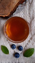 composition still life of honey, blueberries and wood cut