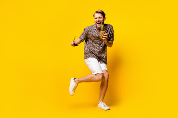 Fototapeta na wymiar Full length photo of cute funky young guy wear leopard outfit arm dark eyewear pineapple dancing isolated yellow color background