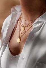 Poster beauty, fashion and jewelry trends concept - close up of woman in white shirt wearing golden multi layer necklace with coin medallions © Syda Productions