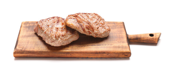 Wooden board with tasty beef steaks on white background