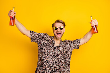 Photo of pretty charismatic young gentleman dressed print shirt dark glasses holding two beer...