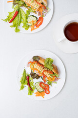 Banh mi sandwiches with various stuffing and cup of tea. Traditional vietnamese breakfast. Trendy still life in light colors, top view, copy space.
