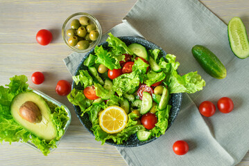 Plate with tasty fresh vegetable salad on wooden table