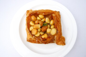 Bread, sachet on delicious Acadimia seeds on white plate isolated on white background.