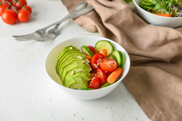 Bowl of delicious vegetables on light table