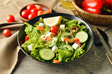 Plate of delicious fresh vegetable salad on table