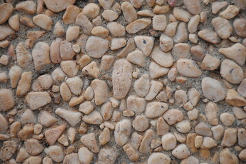 The pebble stone floors and wall, background textures. White granite stone walk way granite stone pavement surface.