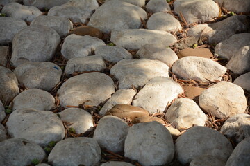 The pebble stone floors and wall, background textures. White granite stone walk way granite stone pavement surface.
