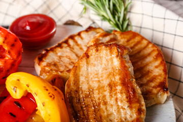Board with tasty grilled vegetables and steaks, closeup
