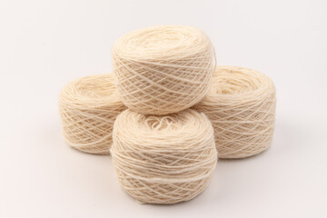 balls of light woolen thread on white background. natural wool. knitting. background