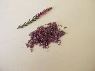 Dried pink heather flowers on a wooden board