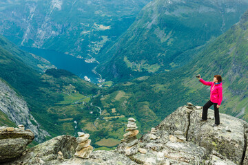 Fototapeta premium Tourist taking photo from Dalsnibba viewpoint Norway