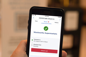 Sydney, Australia 2021-08-03 Mandatory COVID Safe QR-code check in and check out in all venues in NSW. Smartphone with Service NSW app