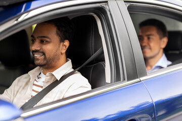 transportation, vehicle and people concept - happy smiling indian male driver driving car with passenger