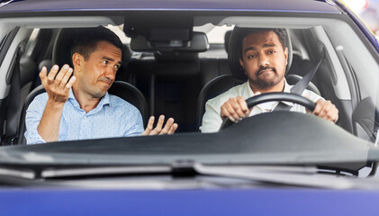 driver courses and people concept - driving school instructor talking to sad man failed exam in car