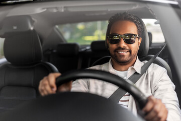 transport, vehicle and people concept - happy smiling indian man or driver in sunglasses driving car - Powered by Adobe