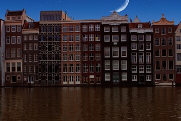 Amsterdam, Holland - The Moon  over traditional houses in the city