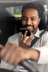 transport, people and technology concept - smiling indian man or driver driving car and recording...