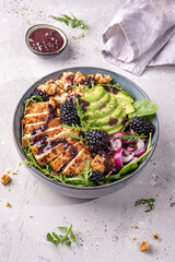 Grilled chicken breast, fillet and fresh vegetable salad of lettuce, arugula, spinach, avocado, onion and walnut with blackberry dressing. Healthy lunch menu. Diet food. Top view