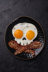 Fried eggs in the shape of a skull. Halloween healthy breakfast