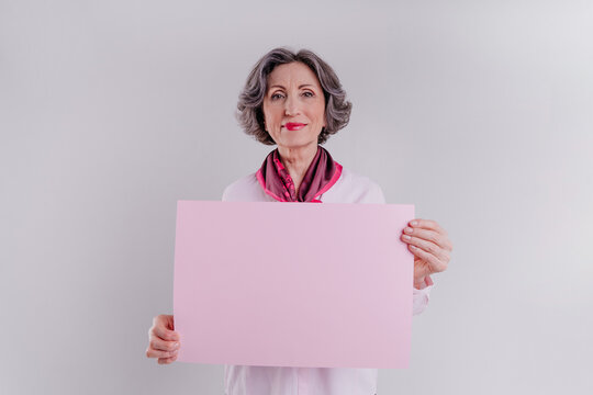 Happy Senior Woman Holding Pink Empty Paper