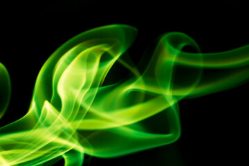 Green smoke on black background.