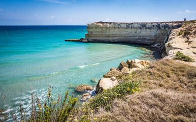 Obraz premium The Punticeddha Beach or Spiaggia Punticeddha of Sant'Andrea, Salento Adriatic sea coast, Apulia, Italy. Beautiful shore with cliffs and rocks of Puglia. Blue water, Summer day, top view
