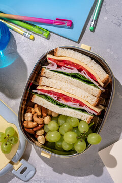 Healthy lunch box with sandwich and fresh fruits and nuts for school lunch