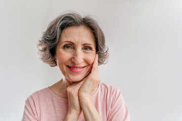 Happy stylish mature woman on light grey background