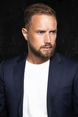 portrait of handsome man wearing suit with t-shirt, hair style and beard