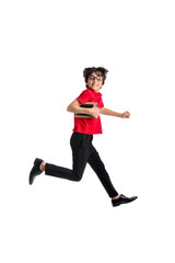 Jumping little schoolboy on white background