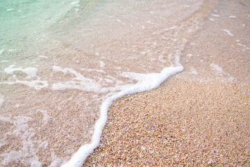 Sea soft wave with sand beach background at coast of ocean. beautiful nature outdoor water. tropical tourist travel vacation holidays in thailand concept.