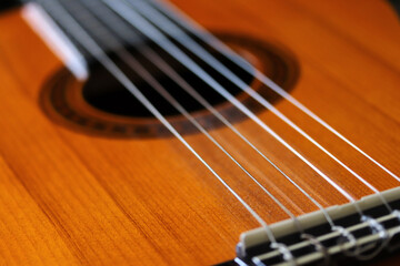 close-up natural wood acoustic guitar