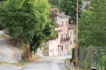 Rural Village Street View with House Facades and Foliage in Central Italy