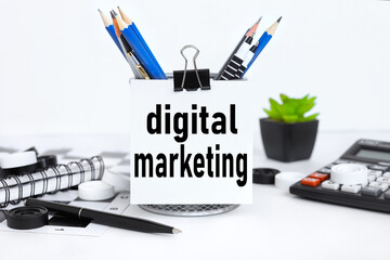 Digital Marketing. text on white paper near pencil holder