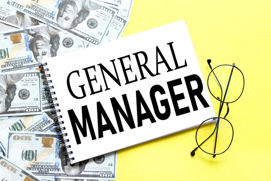 GENERAL MANAGER. background with money, dollar bills and yellow background. text on notepad