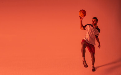 Fototapeta na wymiar Young european sportsman play basketball in studio