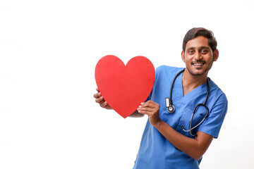 Young male doctor holding a beautiful red heart shape in hand