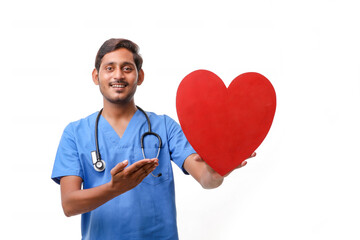 Young male doctor holding a beautiful red heart shape in hand