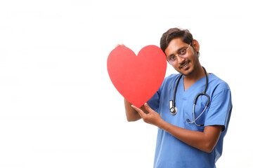 Young male doctor holding a beautiful red heart shape in hand