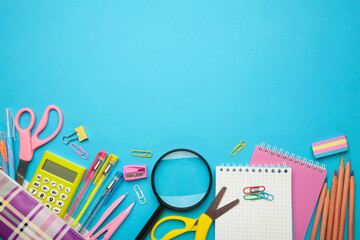 School supplies on blue background with copy space. Back to school concept.