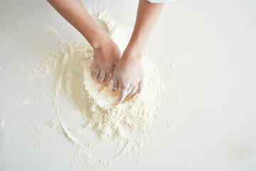 woman baker working with dough in the kitchen cooking pastry
