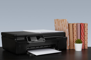 Compact home laser printer against gray background